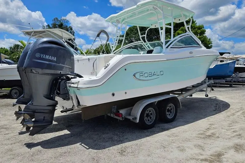 Slide: The Image of 2019 Robalo R247 Dual Console boat on trailer with Yamaha outboard motor. - 2