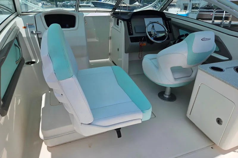 Slide: The Image of 2019 Robalo R247 Dual Console boat interior with helm and seating area. - 22