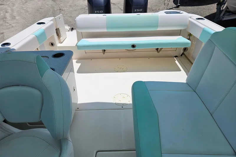 Slide: The Image of 2019 Robalo R247 Dual Console boat interior with seating and cup holders. - 24