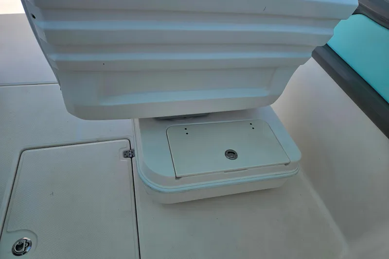 Slide: The Image of 2019 Robalo R247 Dual Console boat interior, featuring storage compartments and seating area. - 29