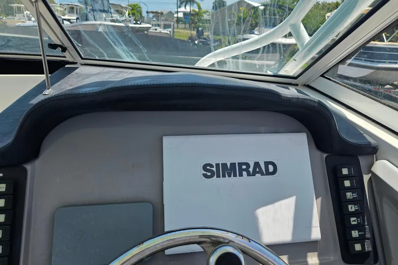 Slide: The Image of 2019 Robalo R247 Dual Console boat dashboard with Simrad navigation system. - 30