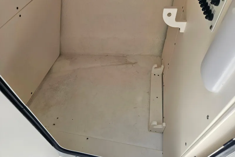 Slide: The Image of Interior storage compartment of 2019 Robalo R247 Dual Console boat. - 34