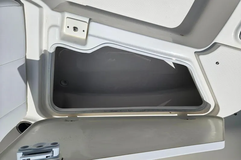 Slide: The Image of 2019 Robalo R247 Dual Console storage compartment, open and empty, showcasing interior space. - 36