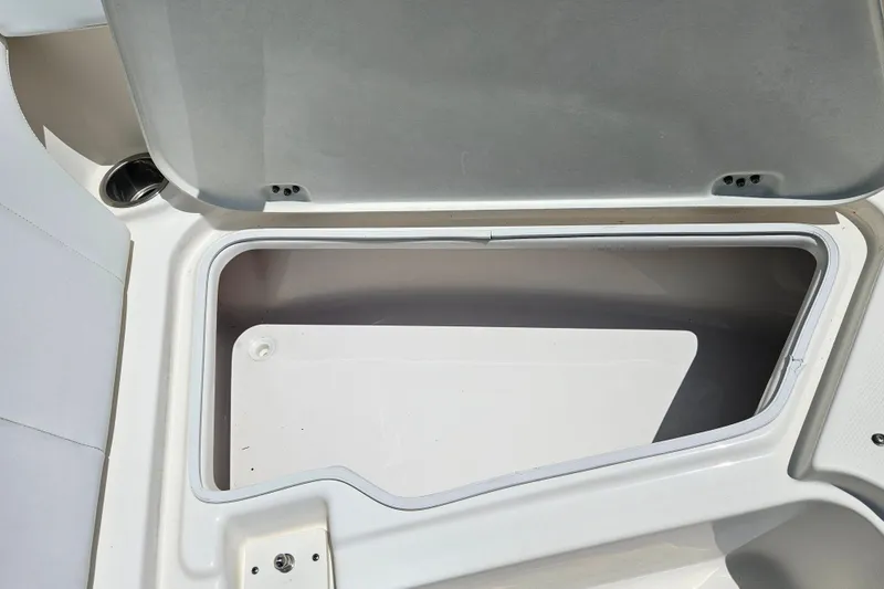 Slide: The Image of 2019 Robalo R247 Dual Console storage compartment, open and empty. - 37