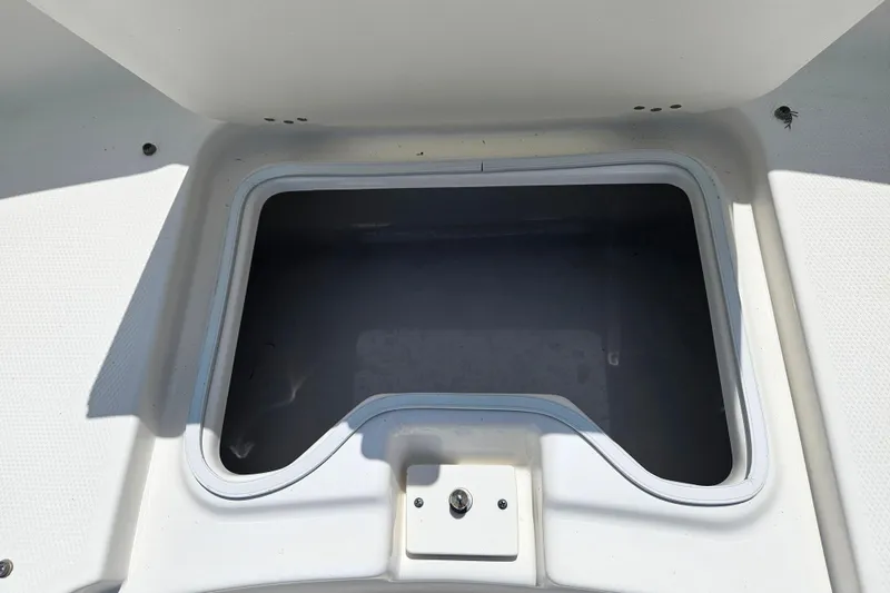Slide: The Image of 2019 Robalo R247 Dual Console storage compartment, open and empty. - 38