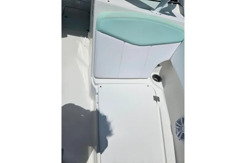 Slide: The Image of 2019 Robalo R247 Dual Console boat interior with white and teal seating. - 40