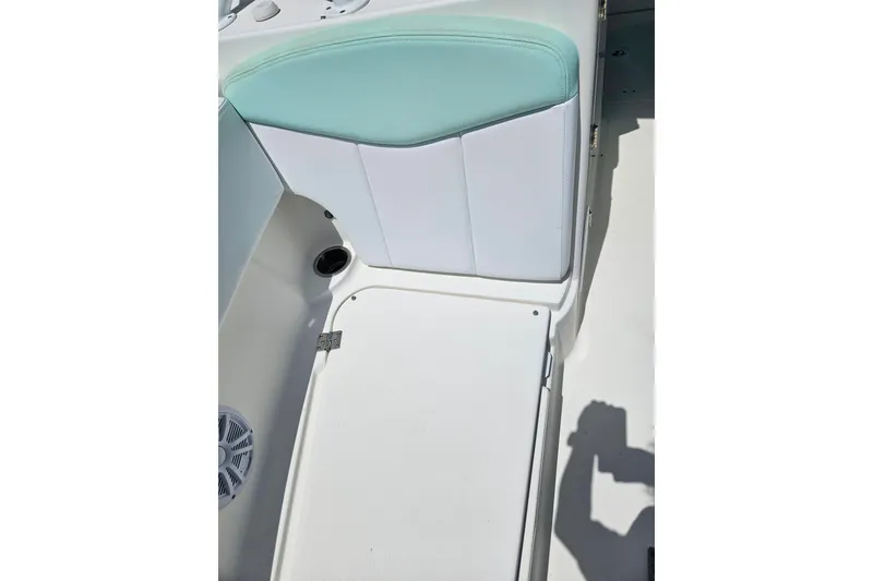 Slide: The Image of 2019 Robalo R247 Dual Console boat interior with white and teal seating. - 41