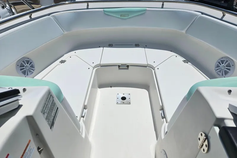 Slide: The Image of 2019 Robalo R247 Dual Console boat interior with seating and storage compartments. - 43