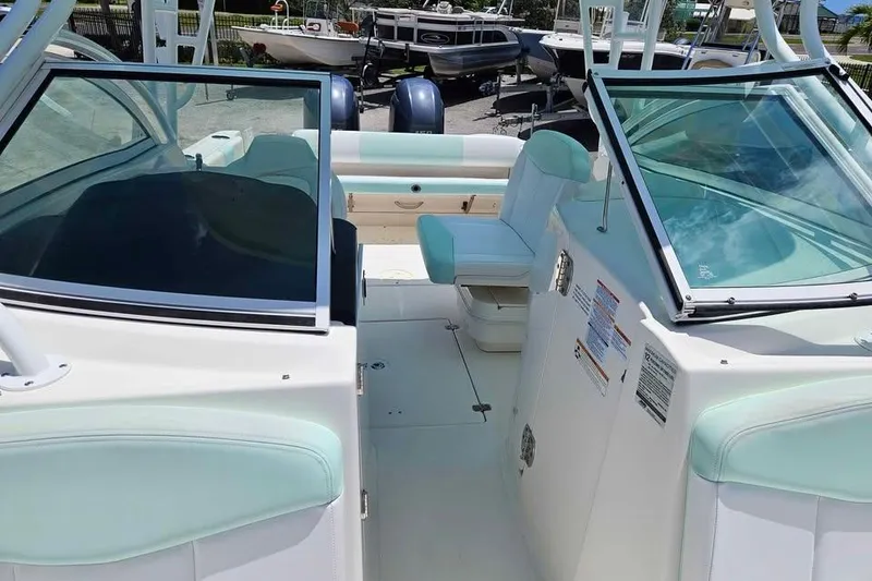 Slide: The Image of 2019 Robalo R247 Dual Console boat interior with seating and windshield. - 5