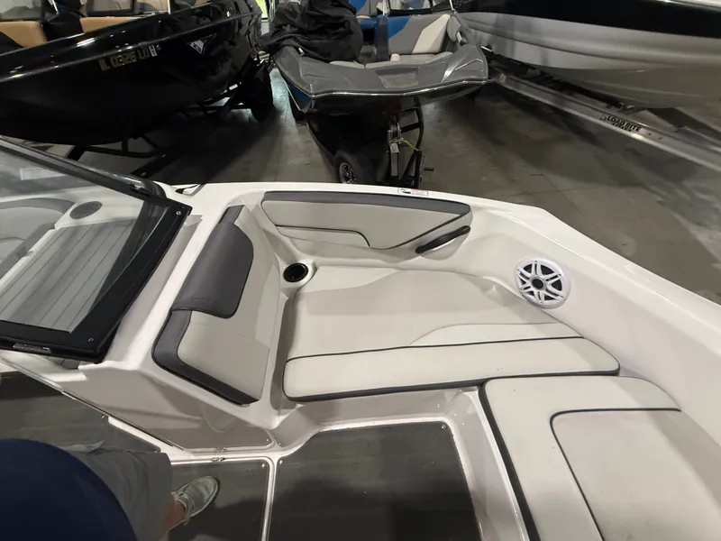 Slide: The Image of The image shows the interior of a 2023 Yamaha AR190 boat with white and gray seating. - 14