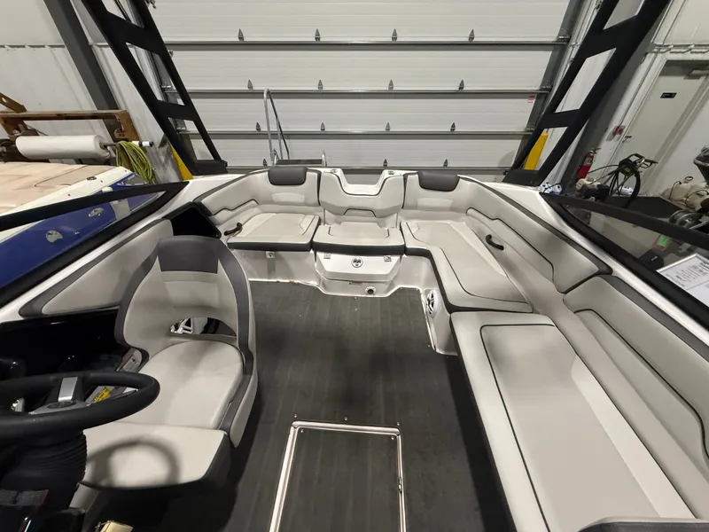 Slide: The Image of Interior view of a Yamaha AR190 boat with gray seating and steering wheel. - 4