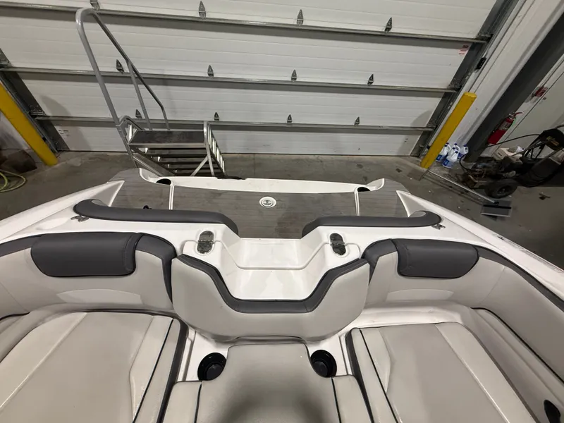Slide: The Image of The image shows the cockpit of a 2023 Yamaha AR190 boat in a storage facility. - 19