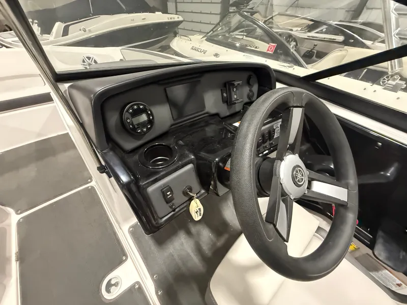 Slide: The Image of The image shows the cockpit of a 2023 Yamaha AR190 boat with steering wheel and instruments. - 10