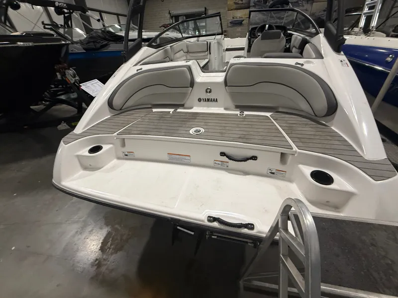 Slide: The Image of The image shows the stern of a 2023 Yamaha AR190 boat with a swim platform. - 20