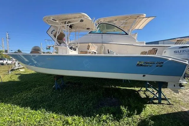 The Image of 2024 Carolina Skiff 26 Ultra Elite boat on display, blue hull, sunny day. - 1