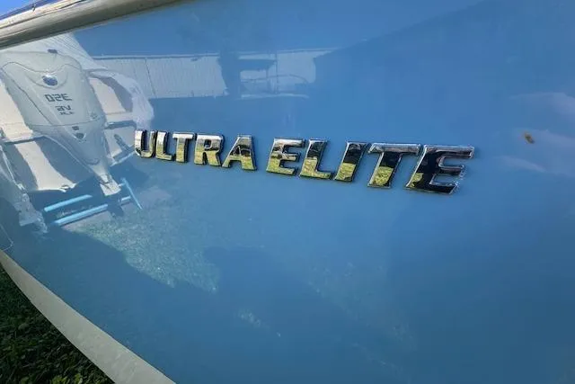 Slide: The Image of 2024 Carolina Skiff 26 Ultra Elite boat with reflective blue hull and chrome lettering. - 3