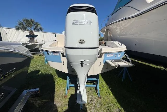Slide: The Image of 2024 Carolina Skiff 26 Ultra Elite boat with powerful 250 engine, displayed outdoors. - 6
