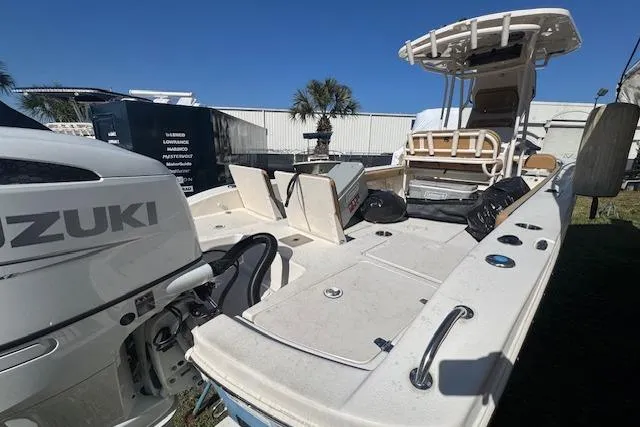 Slide: The Image of 2024 Carolina Skiff 26 Ultra Elite boat with Suzuki engine, docked outdoors. - 9