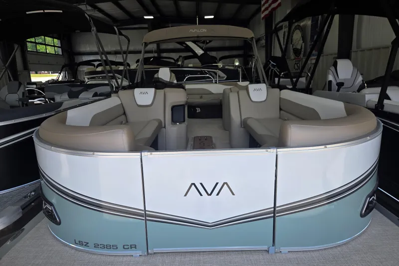 The Image of 2026 Avalon Platinum LSZ 2385 Cruise pontoon boat in showroom, featuring elegant seating. - 0