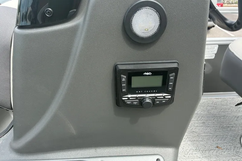 Slide: The Image of 2026 Sun Tracker Bass Buggy 18 DLX dashboard with Wet Sounds audio system. - 14