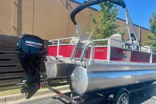 Slide: The Image of 2026 Sun Tracker Bass Buggy 18 DLX pontoon boat with Mercury outboard motor. - 1