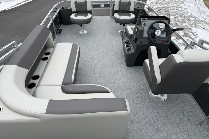 Slide: The Image of 2026 Sun Tracker Bass Buggy 18 DLX pontoon boat interior with seating and steering console. - 2