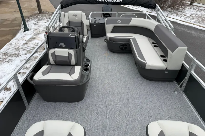 Slide: The Image of 2026 Sun Tracker Bass Buggy 18 DLX pontoon boat interior with gray seating and carpet. - 3