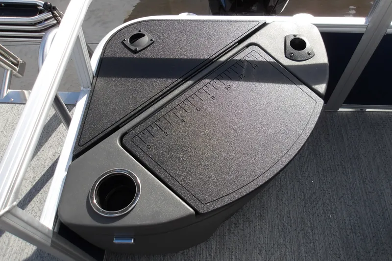 Slide: The Image of 2026 Sun Tracker Bass Buggy 18 DLX fishing station with built-in ruler and cup holder. - 17