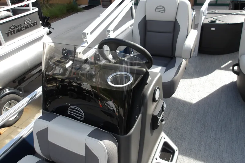 Slide: The Image of 2026 Sun Tracker Bass Buggy 18 DLX interior with steering console and seating. - 20