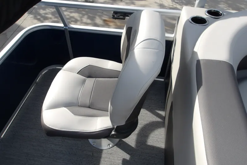 Slide: The Image of 2026 Sun Tracker Bass Buggy 18 DLX boat seat with cup holders and railing. - 16