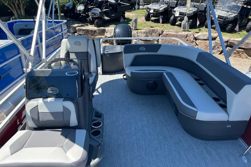 Slide: The Image of 2026 Sun Tracker Bass Buggy 18 DLX pontoon boat interior with seating and steering console. - 84
