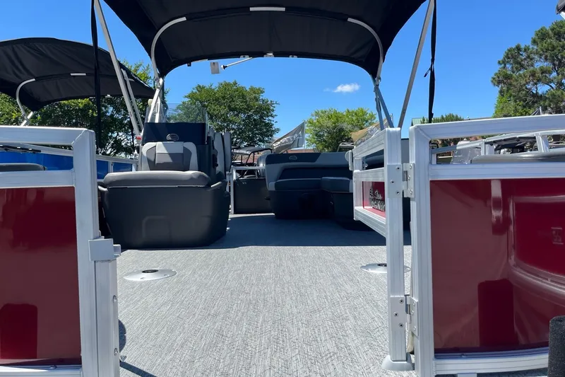 Slide: The Image of 2026 Sun Tracker Bass Buggy 18 DLX pontoon boat interior with seating and canopy. - 4