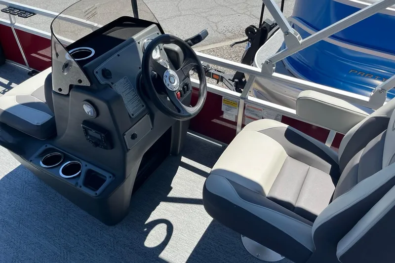 Slide: The Image of 2026 Sun Tracker Bass Buggy 18 DLX boat interior with steering console and seating. - 6