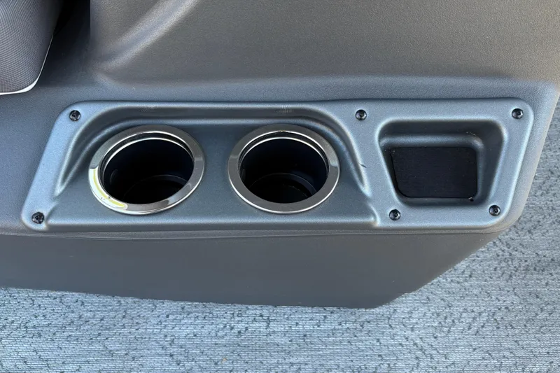 Slide: The Image of 2026 Sun Tracker Bass Buggy 18 DLX cup holders and storage compartment detail. - 32