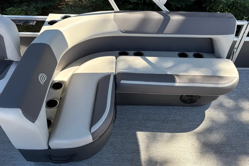 Slide: The Image of 2026 Sun Tracker Bass Buggy 18 DLX pontoon boat seating with cup holders and gray upholstery. - 41