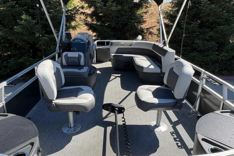 Slide: The Image of 2026 Sun Tracker Bass Buggy 18 DLX pontoon boat interior with seating and steering console. - 24