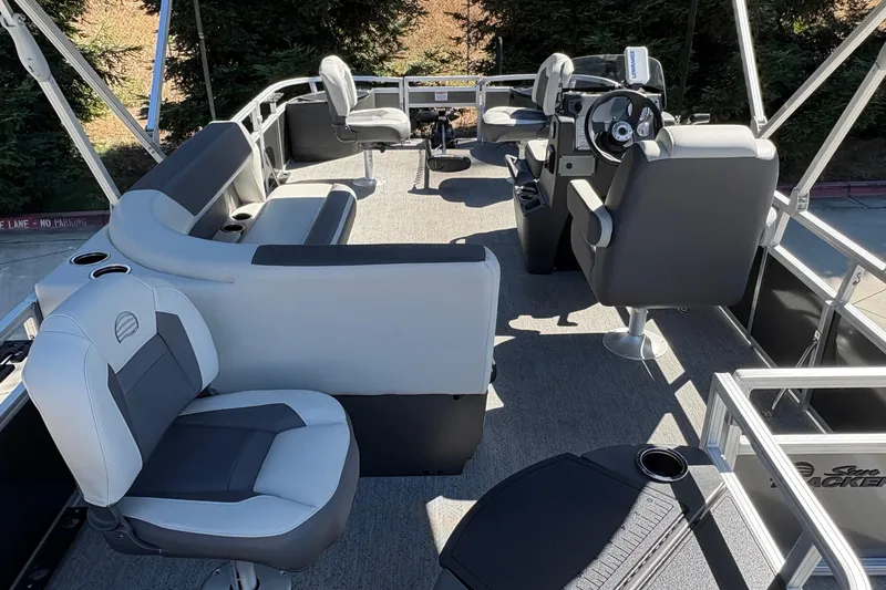 Slide: The Image of 2026 Sun Tracker Bass Buggy 18 DLX pontoon boat interior with seating and steering console. - 20