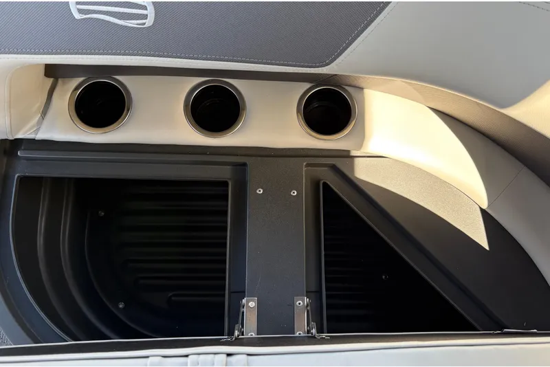 Slide: The Image of Interior view of 2026 Sun Tracker Bass Buggy 18 DLX with cup holders and storage compartment. - 38