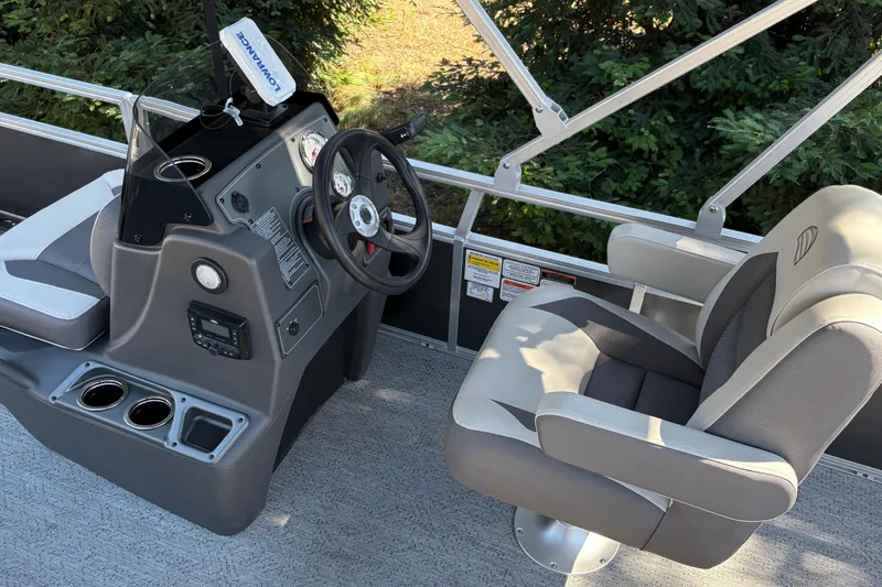 Slide: The Image of 2026 Sun Tracker Bass Buggy 18 DLX boat interior with steering console and seating. - 27