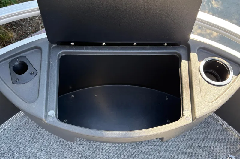 Slide: The Image of 2026 Sun Tracker Bass Buggy 18 DLX storage compartment with cup holders and rod holder. - 42