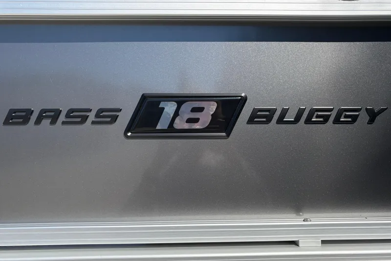 Slide: The Image of 2026 Sun Tracker Bass Buggy 18 DLX logo on metallic surface. - 13