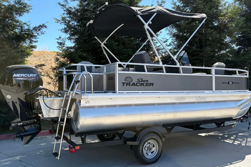 Slide: The Image of 2026 Sun Tracker Bass Buggy 18 DLX pontoon boat with Mercury engine on trailer. - 11