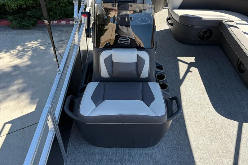 Slide: The Image of 2026 Sun Tracker Bass Buggy 18 DLX interior with seating and console. - 26