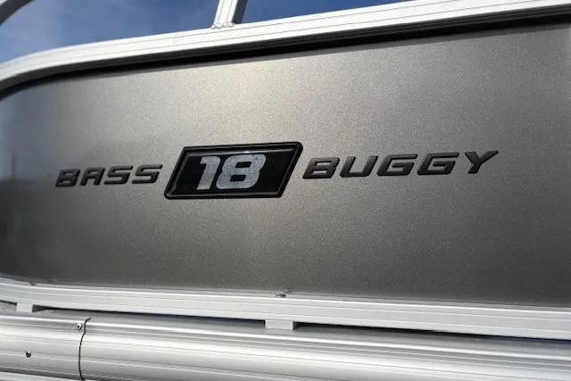 Slide: The Image of 2026 Sun Tracker Bass Buggy 18 DLX logo on metallic surface. - 102