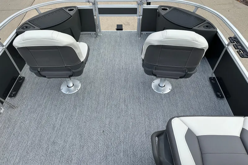 Slide: The Image of 2026 Sun Tracker Bass Buggy 18 DLX interior with swivel seats and carpeted deck. - 3