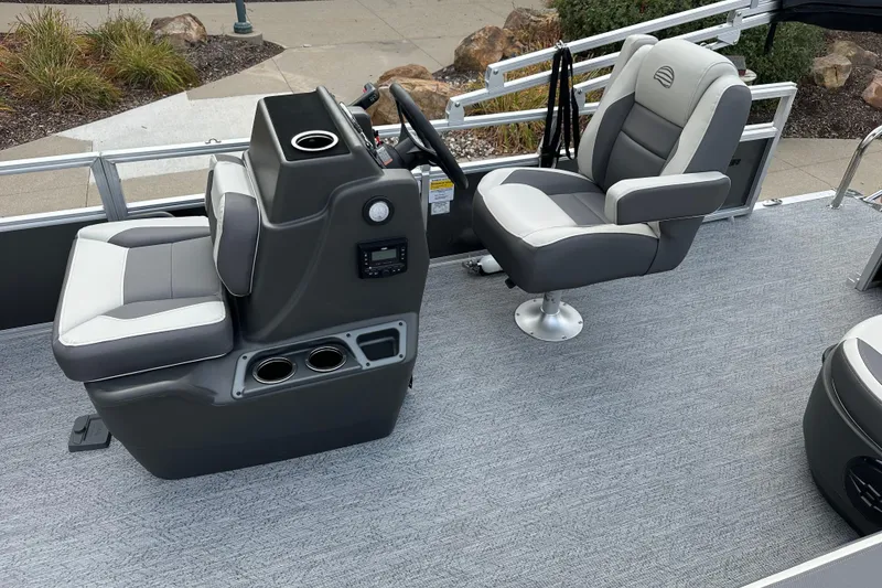 Slide: The Image of 2026 Sun Tracker Bass Buggy 18 DLX interior with gray seating and console. - 6