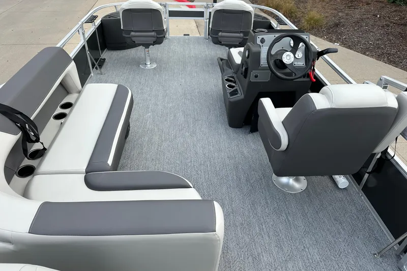 Slide: The Image of 2026 Sun Tracker Bass Buggy 18 DLX pontoon boat interior with seating and steering console. - 8