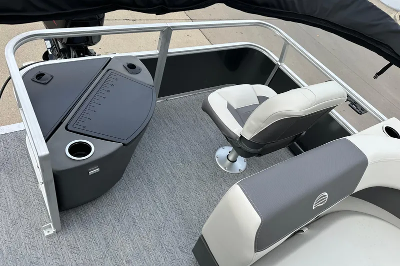 Slide: The Image of 2026 Sun Tracker Bass Buggy 18 DLX interior with seating and fishing station. - 9