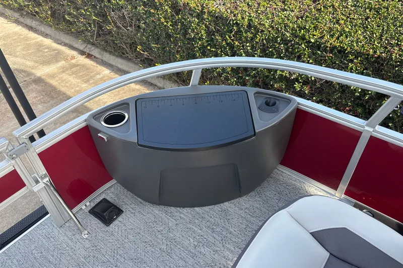 Slide: The Image of 2026 Sun Tracker Bass Buggy 18 DLX boat interior with cup holder and measuring board. - 25