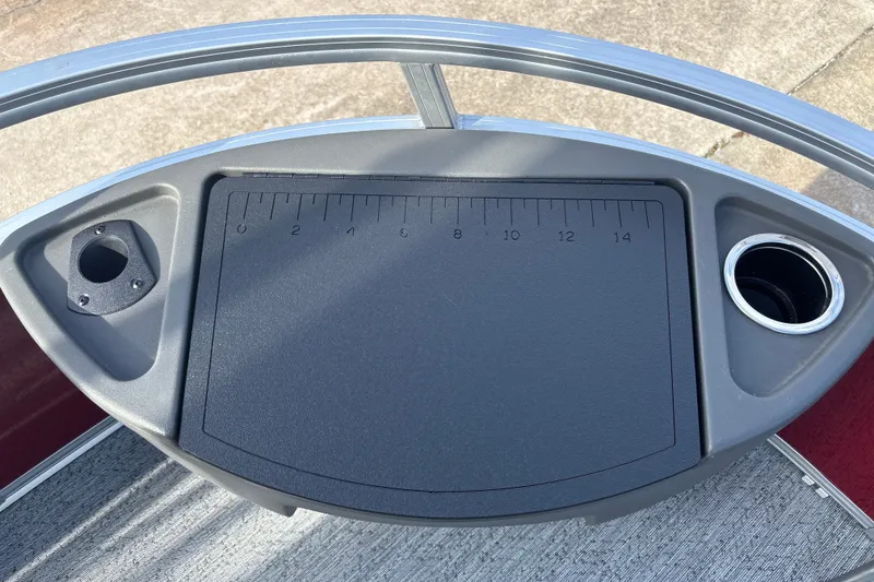 Slide: The Image of Sun Tracker Bass Buggy 18 DLX 2026 boat console with cup holders and measuring board. - 28